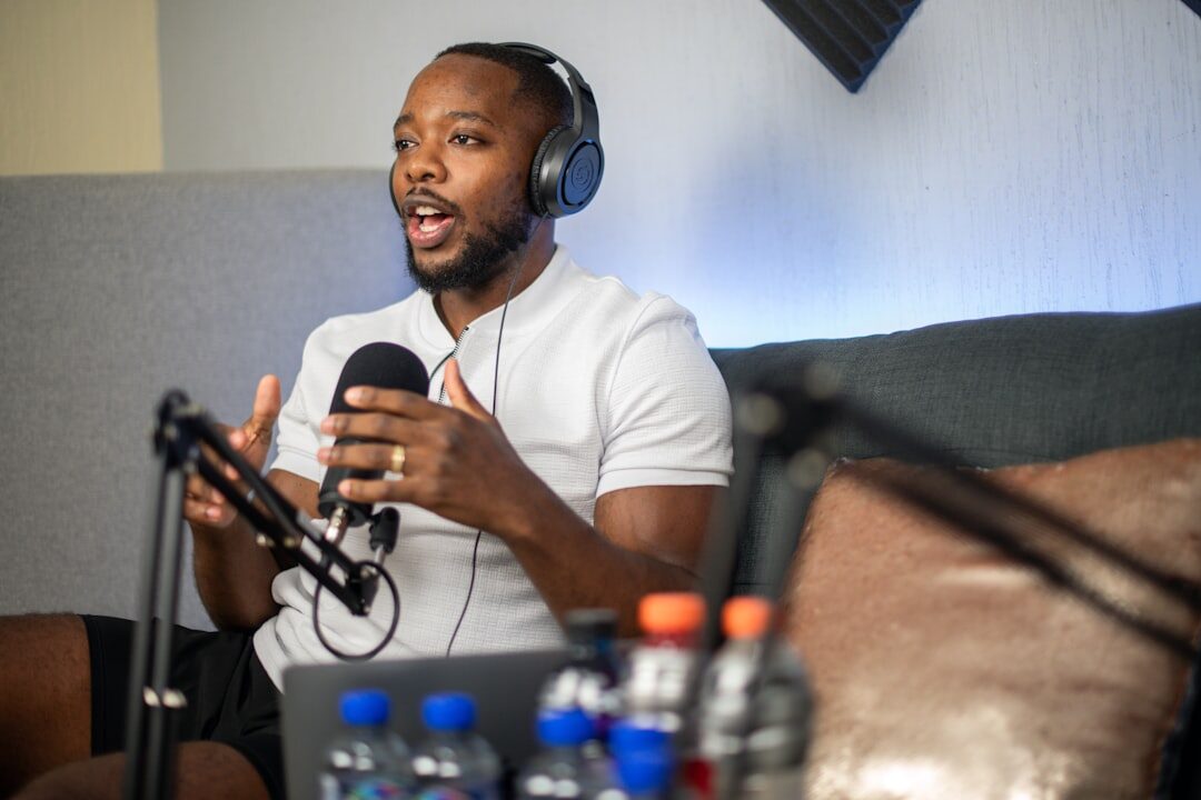 Person conducting a professional interview with microphone and notes 