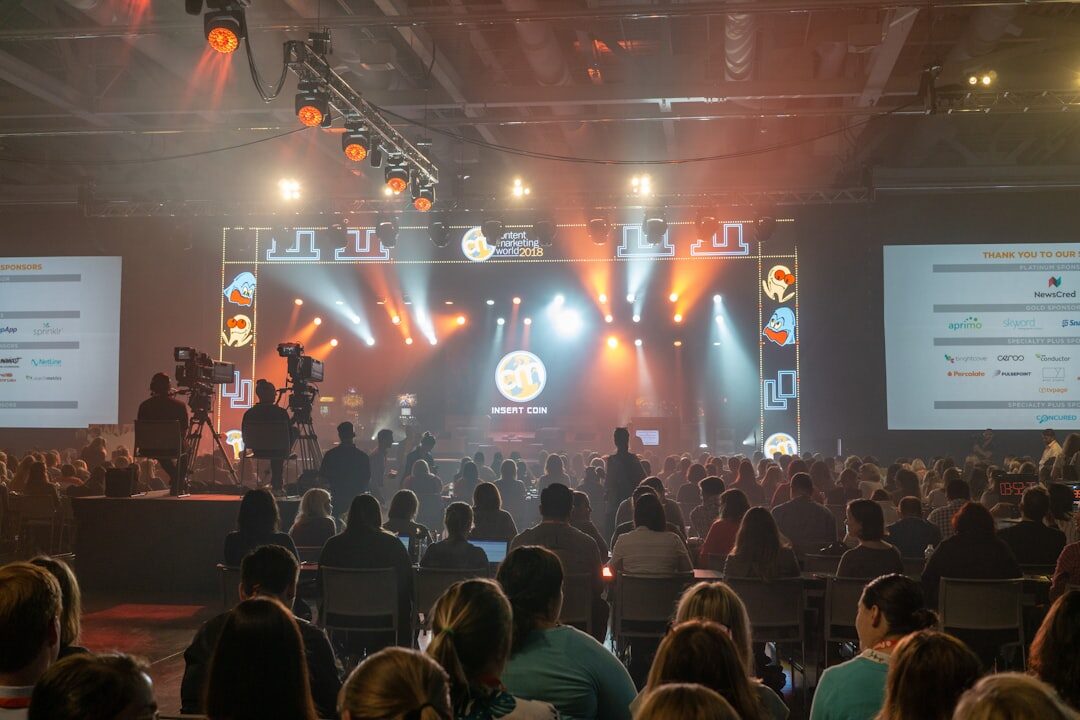 Panel discussion at a conference with multiple speakers on stage 